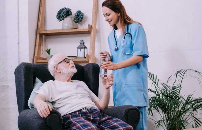 nurse-giving-old-man-a-glass-of-water-2024-11-09-09-09-51-utc.jpg
